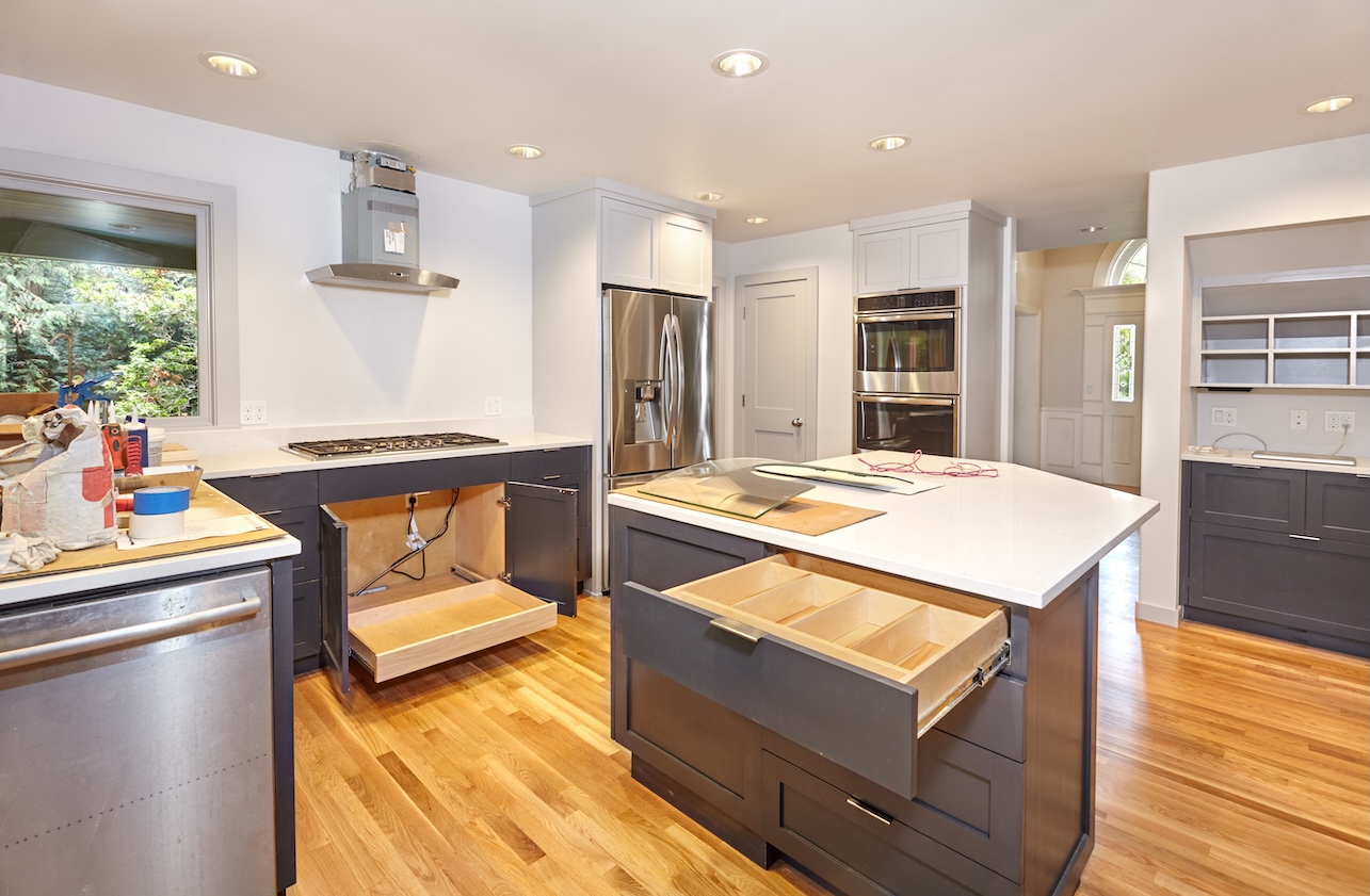 Drawer inserts and pullout tray installed in custom kitchen cabinets during kitchen remodel